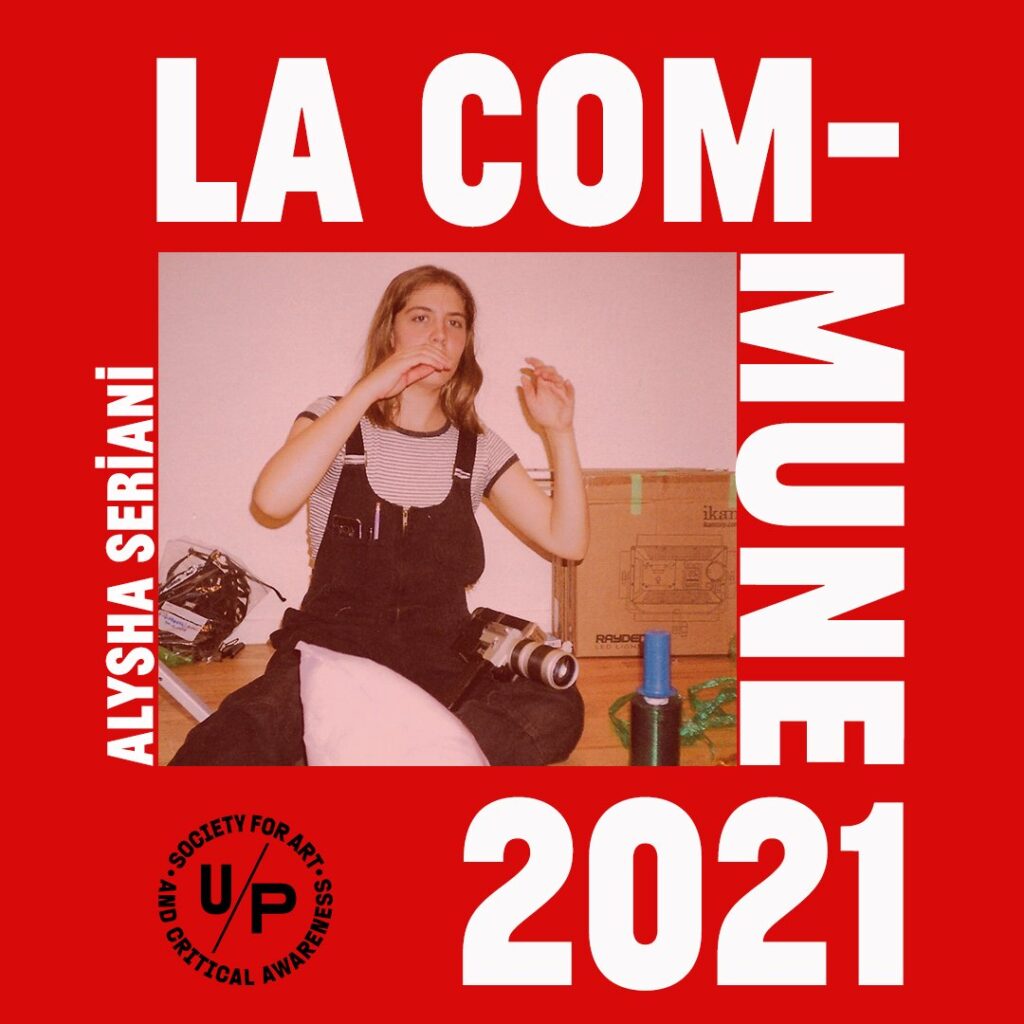 Promotional image for LACOMMUNE2021 Artist in Residence Alysha Seriani. The words LA COMMUNE 2021 in white all caps text and the black U/P logo surround a tinted red image of the artist sitting cross-legged on the floor amidst photo and moving ephemera with their arms half up as if mid-gesture. 