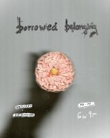a grey background poster with a salmon-pink dahlia pressed against a scanner-bed. a shadowy hand is in the background, presumably holding the stem. text reads 'borrowed belonging' along with dates and location.